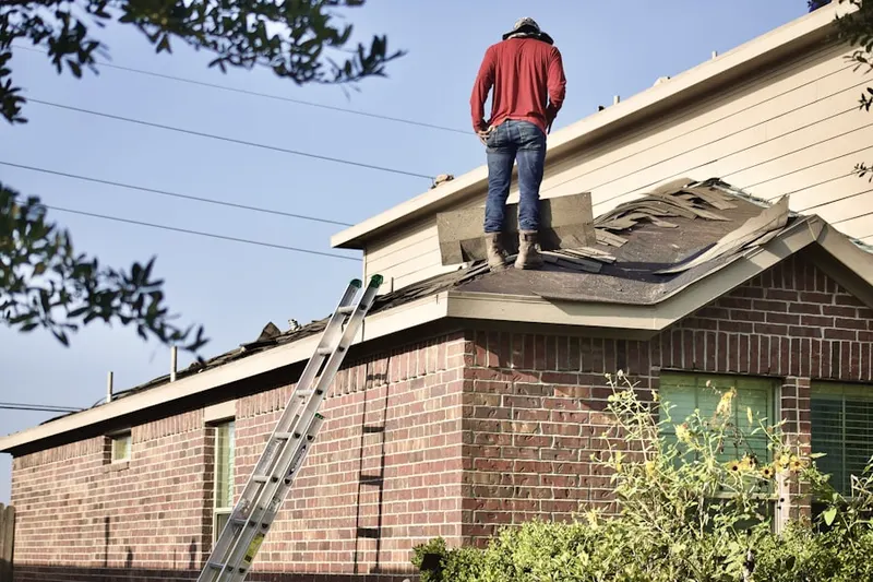 Professional roofer working on a residential roof in Lafayette Square